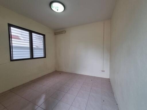 Empty bedroom with tiled floor and window