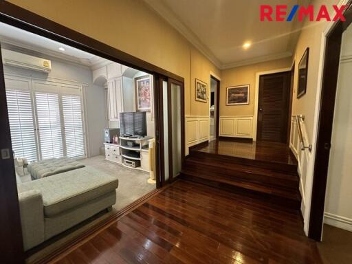 Spacious living room with sectional sofa and wooden flooring