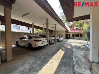 Covered parking area with multiple parked cars