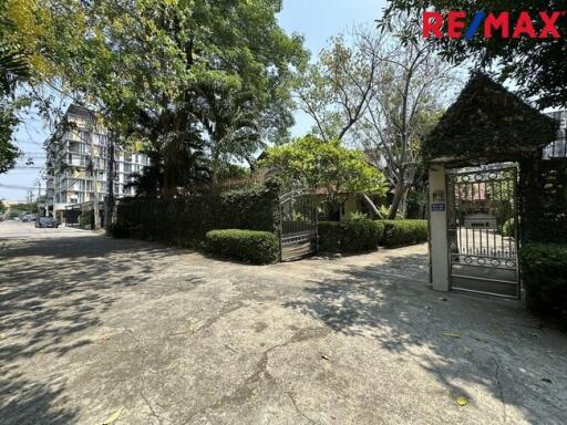 A view of the exterior entrance of a property with driveway and gate