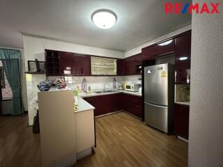 Modern kitchen with red cabinets and stainless steel appliances