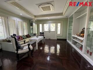 Spacious living room with large windows and built-in shelving