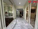 Spacious hallway with marble flooring and glass doors