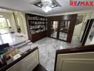 Spacious living room with bookshelves and marble flooring