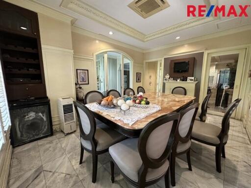 Spacious dining room with a marble table and elegant chairs