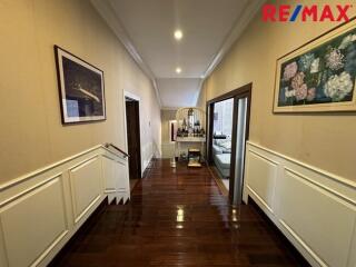 Spacious hallway with wall art and wooden flooring