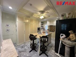 Modern white kitchen with marble countertops and center island