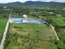 Aerial view of an industrial complex surrounded by greenery