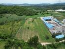 Aerial view of a large plot of agricultural land with nearby buildings