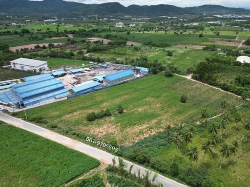 Aerial view of expansive green farmland with structures