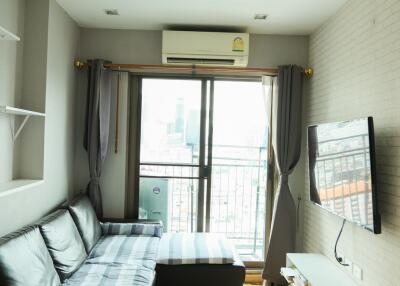 Modern living room with balcony and mounted TV