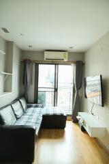 Modern living room with balcony and mounted TV