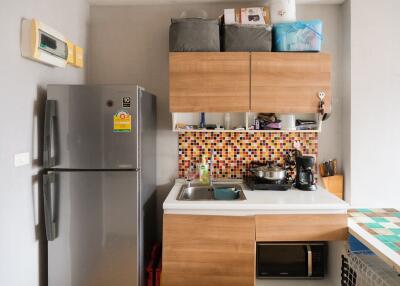 Cozy modern kitchen with refrigerator and cabinets