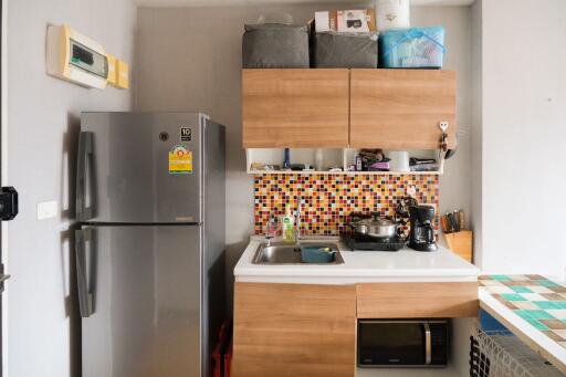 Cozy modern kitchen with refrigerator and cabinets