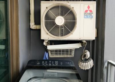 utility space with washing machine and air conditioning units