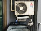 utility space with washing machine and air conditioning units