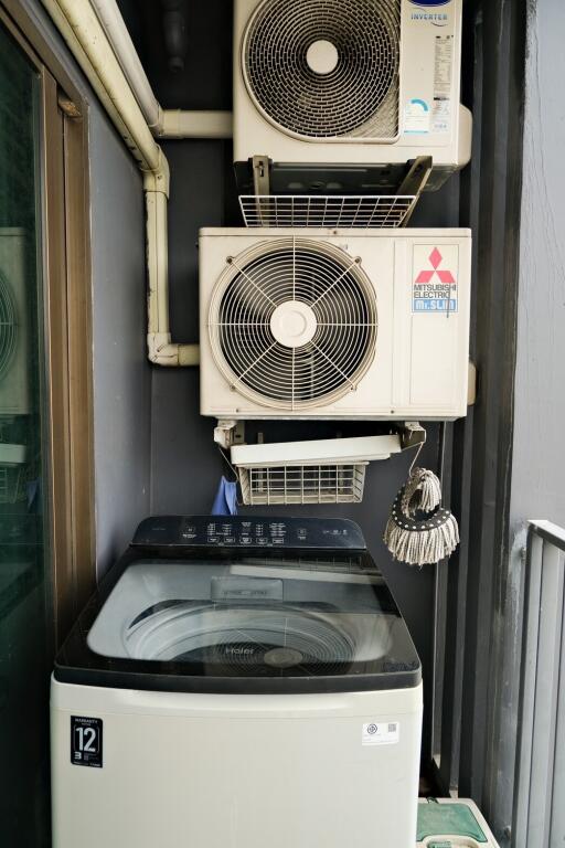 utility space with washing machine and air conditioning units