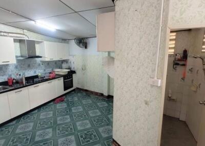 Spacious kitchen with tiled flooring and modern appliances