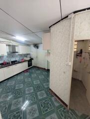 Spacious kitchen with tiled flooring and modern appliances