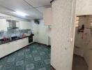 Spacious kitchen with tiled flooring and modern appliances