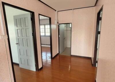 Hallway with wooden floor and multiple doors