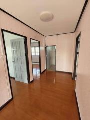 Hallway with wooden floor and multiple doors