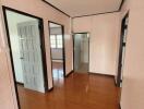 Hallway with wooden floor and multiple doors