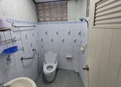Small bathroom with toilet, sink, and shower
