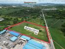 Aerial view of a plot of land with boundary marks and contact information