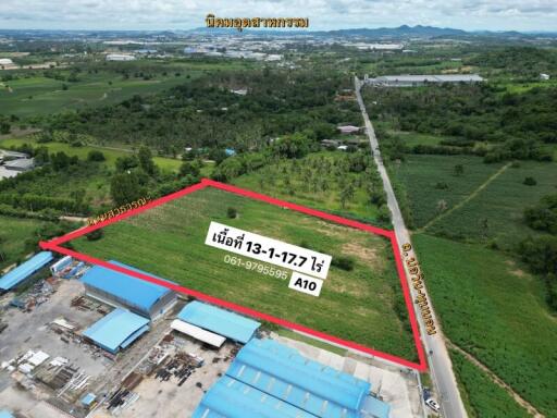 Aerial view of a plot of land with boundary marks and contact information