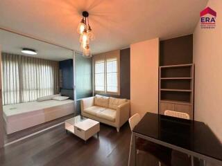 Modern living area with a view into the bedroom