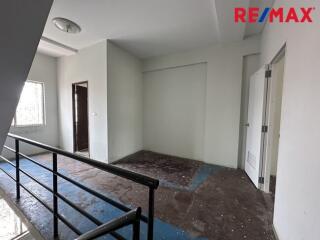 Unfurnished room in a building with staircase view