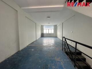 empty room with blue floor and staircase