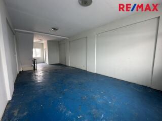 Empty room with blue flooring and white walls