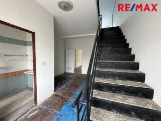 Staircase area with bathroom entrance