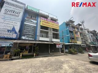 Exterior view of a commercial building with multiple floors and signage