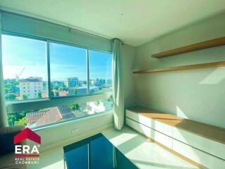 Bright living room with large window and city view