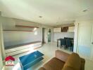 Modern living room with brown sofa and dining area