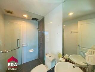 Modern bathroom with glass shower enclosure and large mirror