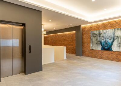 Modern building lobby with elevator and artwork