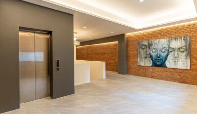 Modern building lobby with elevator and artwork