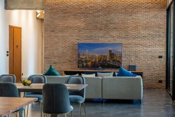 Modern living room with exposed brick wall and television