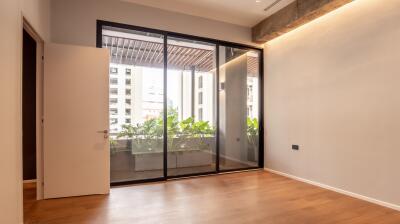 Bedroom with large glass doors leading to a balcony