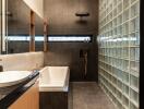 Modern bathroom with bathtub and glass block wall