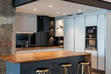 Modern kitchen with wooden island and integrated appliances