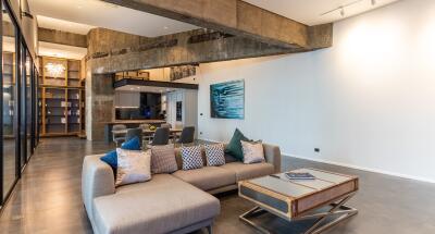 Modern living room with exposed concrete beams and stylish furniture