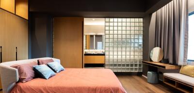 Modern bedroom with glass block partition and ensuite bathroom