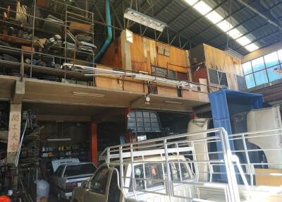 Interior of a warehouse with vehicles and storage shelves