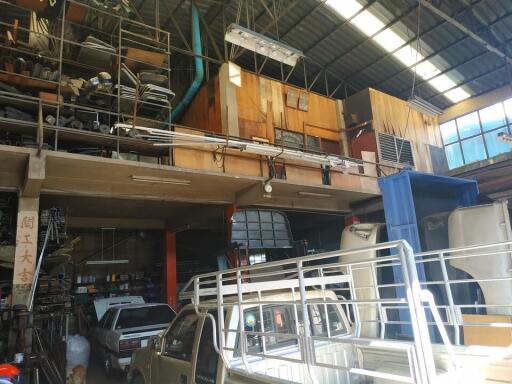 Interior of a warehouse with vehicles and storage shelves