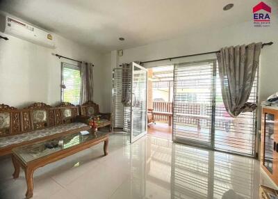 Bright living room with traditional wooden furniture and large sliding glass doors